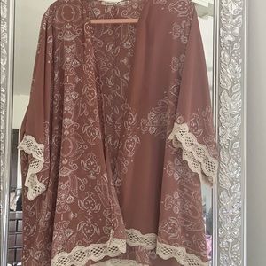 Kimono style, with lace on hem and sleeves